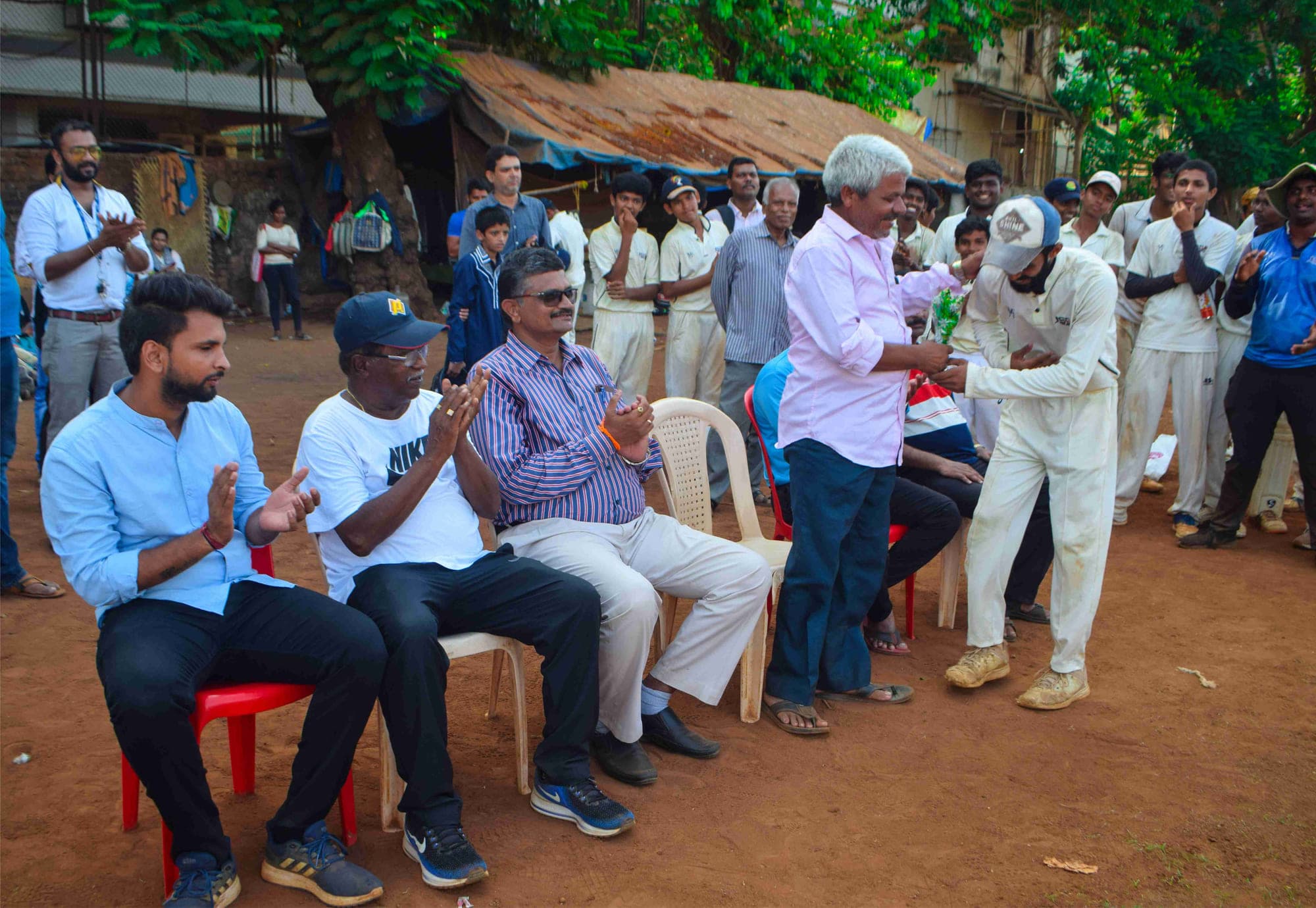 Guests and players seated at an academy presentation