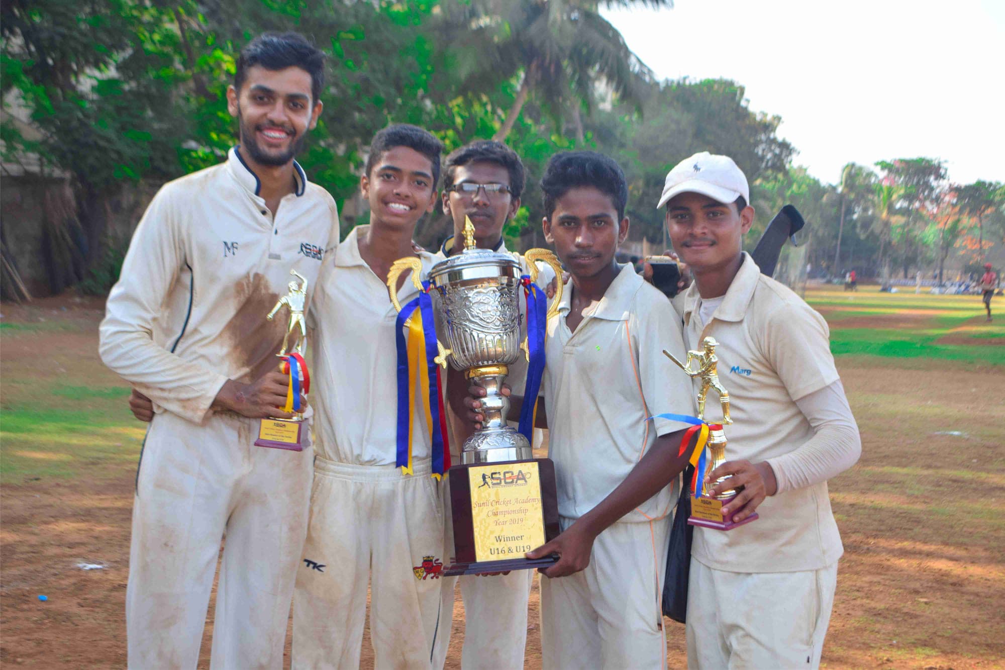 Academy players holding a trophy